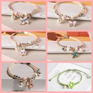 2 ADJUSTABLE BEADED, GLAZED CHARM, CORDED BRACELETS‎